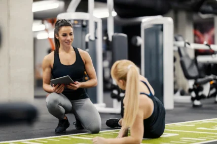 personal trainer helps a client