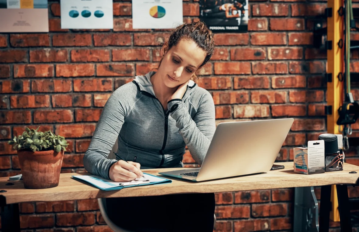 female personal trainer sits at a desk
