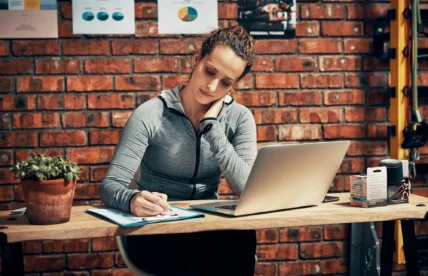 female personal trainer sits at a desk
