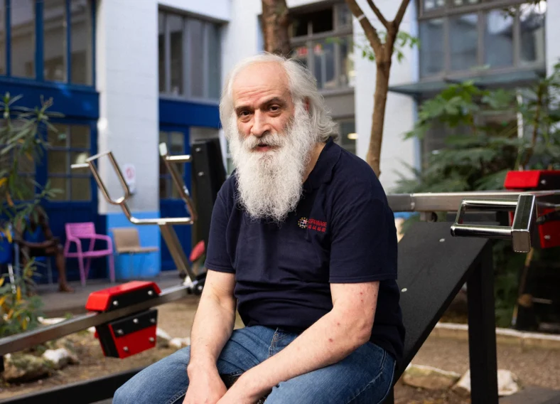 homeless man at an outdoor gym in Paris