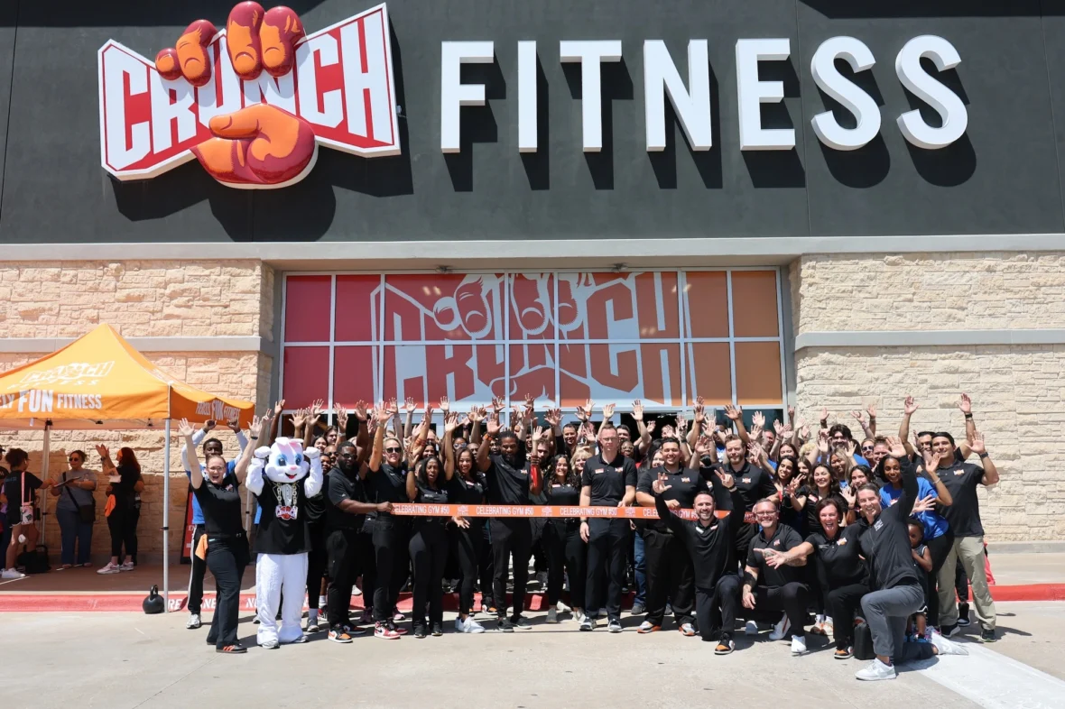 Undefeated Tribe team members outside a Crunch Fitness gym