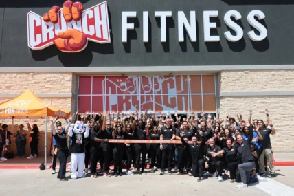 Undefeated Tribe team members outside a Crunch Fitness gym