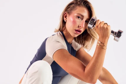 Gabby George holds a dumbbell