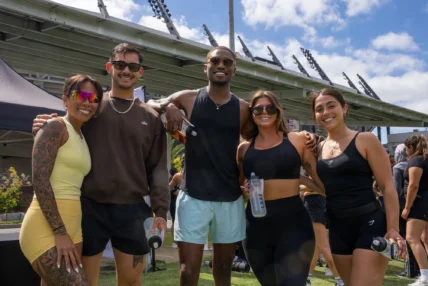 people pose for a photo at a fitness event