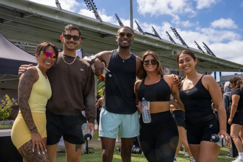 people pose for a photo at a fitness event