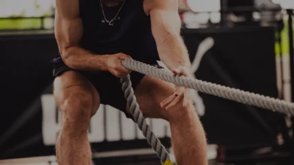 man pulls a rope in a Hyrox competition