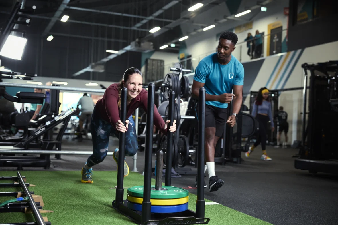 woman pushes a sled in a PureGym
