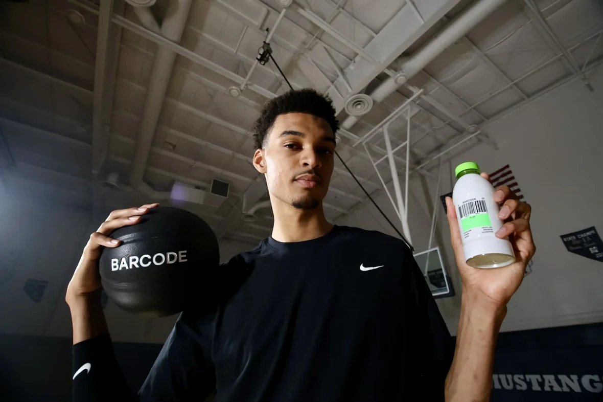 Victor Wembanyama holding a Barcode drink