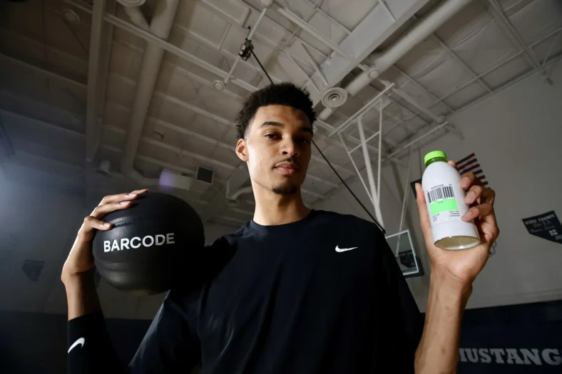 Victor Wembanyama holding a Barcode drink