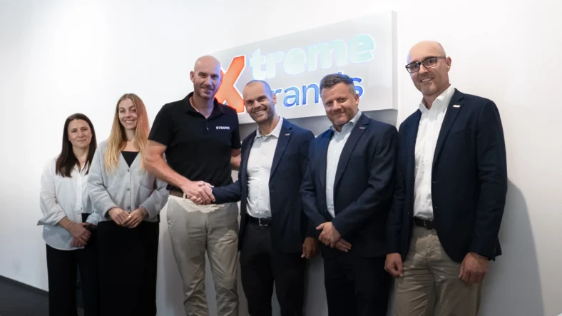 Strong Pilates and Extreme Brands executives post for a photo