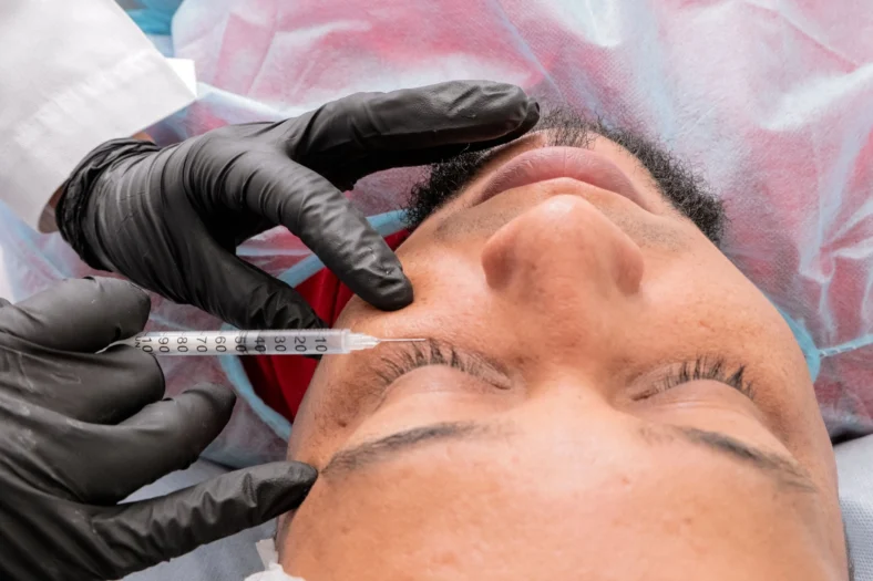 man gets injected with a peptide in the cheek