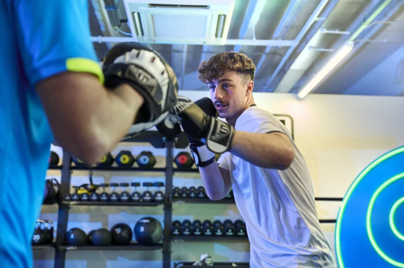 young man boxes inside a gym