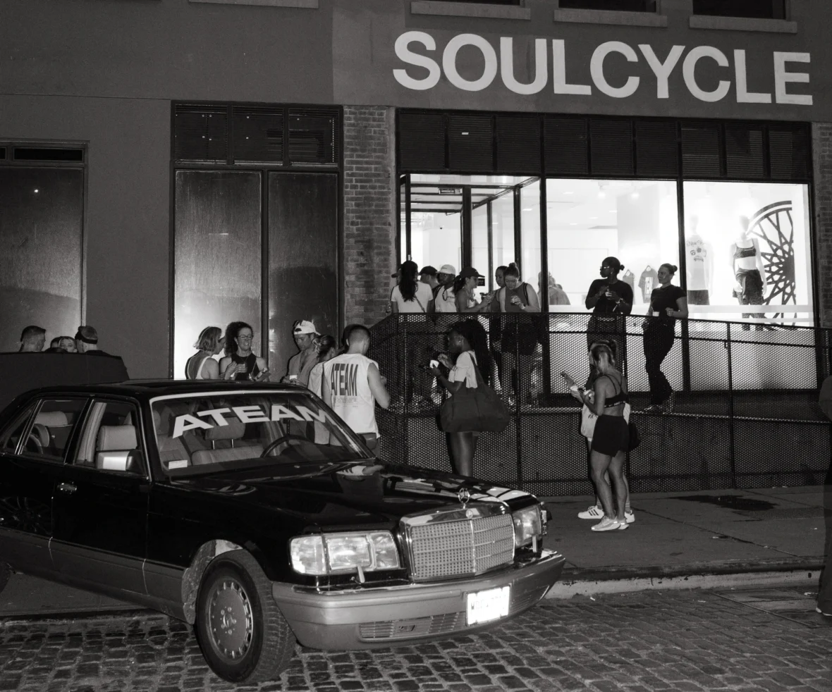 people gather near an Ateam-branded car