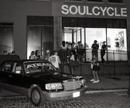 people gather near an Ateam-branded car