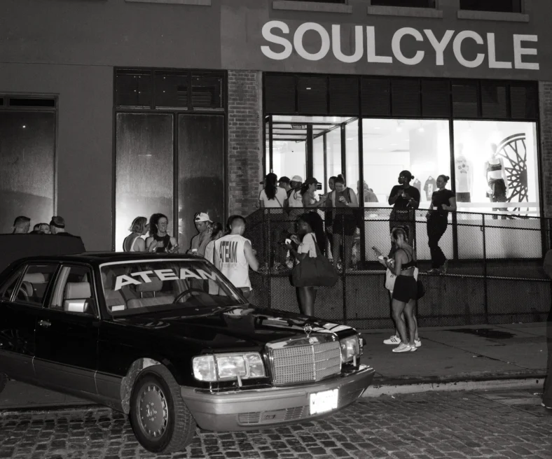 people gather near an Ateam-branded car
