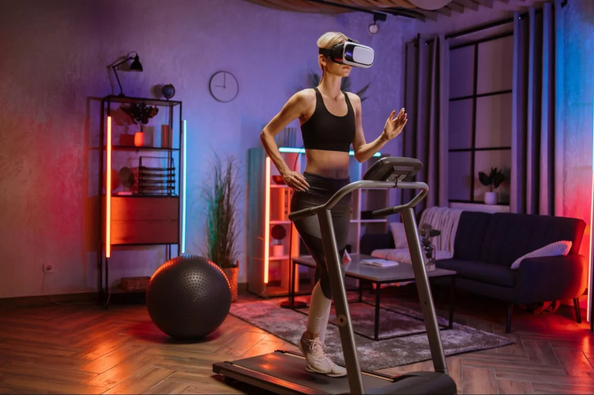 woman on a treadmill wears a VR fitness headset